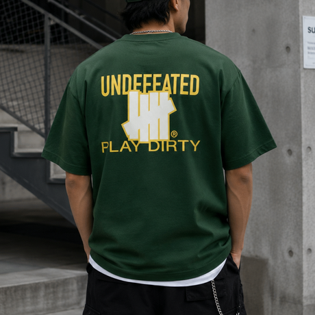 Forest green Undefeated Trademark Tee featuring the brand's logo on the front, displayed on a plain background.