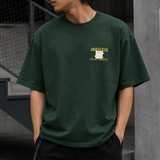 Undefeated Trademark Tee in forest green, casual men's t-shirt with brand logo on front, made from soft cotton fabric.