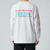 Takashi Murakami white long sleeve tee featuring embroidered sakura flower patch, casual apparel with artistic design.