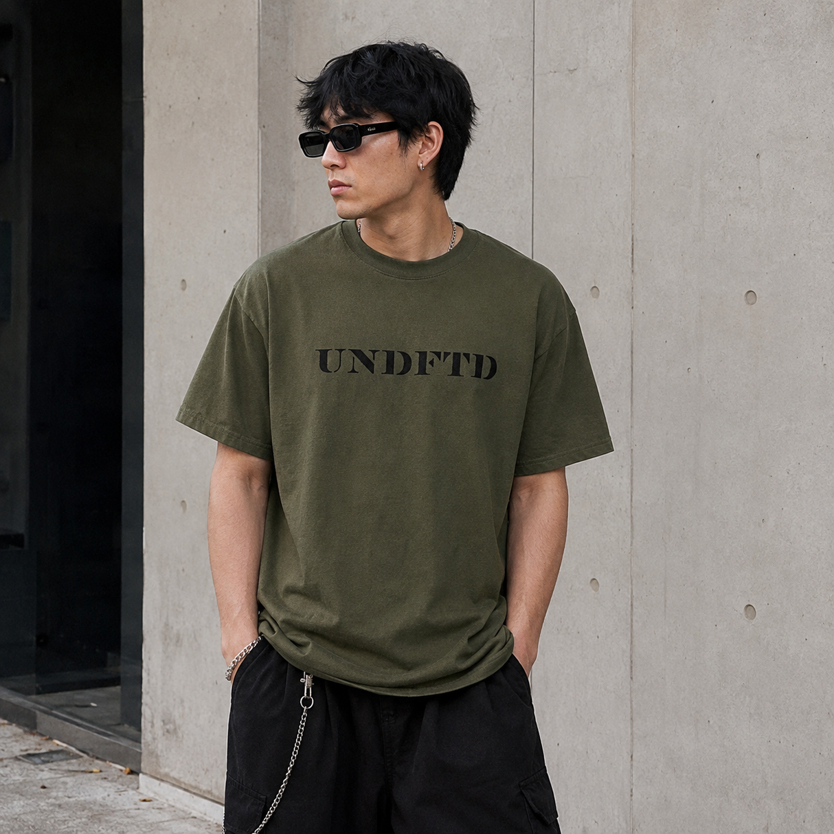 Olive green Undefeated Stencil Logo T-shirt with front print, casual fit, made by UNDEFEATED, displayed flat on a white background.