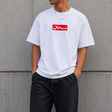 White Supreme Arabic Box Logo T-shirt displayed on a hanger, showcasing the classic box logo design and clean fit.