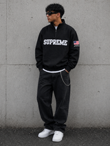 Black Supreme half zip pullover, United States Edition, casual apparel with a sleek design and front zipper detail.