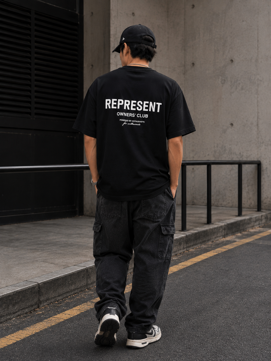 Black REPRESENT Owners Club Logo T-shirt featuring the brand's distinctive graphic on the front.