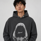 Represent Shark Jaws Hoodie in Off Black, featuring a bold shark graphic design on the front, casual streetwear style.