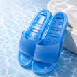 Balenciaga transparent slides in blue, showing clear plastic straps and blue soles, stylish and modern footwear.