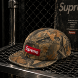 Supreme Box Logo Chino Twill Cap in Tree Camo, showcasing adjustable brim and embroidered Supreme logo on headwear.