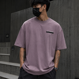 AllSaints Redact Strikeout Logo Tee in puce purple, casual t-shirt with bold logo graphic and relaxed fit.