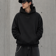 Black Fear of God Essentials hoodie with applique box logo, casual apparel featuring a front graphic, comfortable and stylish.