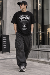 Black Stussy World Tour Tee shirt featuring a graphic design, casual streetwear apparel by Stussy.