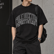 Cole Buxton vintage black tee with arch logo, casual apparel featuring minimalist design and comfortable fit.