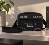 Black Supreme Reflective Monogram Logo Mini Shoulder Bag with sleek design and adjustable strap, ideal for compact carrying.