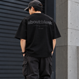 Black ABOUT:BLANK Box Logo Tee shirt with a minimalist box logo on the front, casual apparel for everyday wear.
