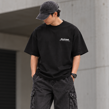 Black AboutBlank Zev Logo Tee shirt, casual apparel with graphic logo design, displayed on a flat surface.