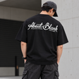 Black AboutBlank Banner Tee from ABOUT:BLANK, featuring a graphic banner design on a casual t-shirt.