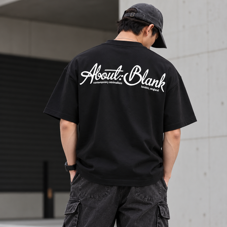 Black AboutBlank Banner Tee from ABOUT:BLANK, featuring a graphic banner design on a casual t-shirt.