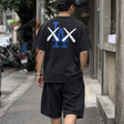 Black MLB X KAWS X Nike Los Angeles Dodgers T-shirt featuring graphic design and branding on soft cotton fabric.