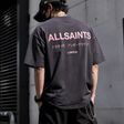 AllSaints Underground Logo Tee in washed black with pink logo print, casual men's apparel, front view of the T-shirt.