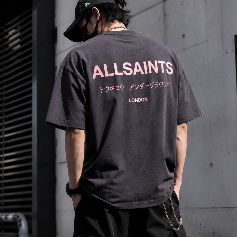 AllSaints Underground Logo Tee in washed black with pink logo print, casual men's apparel, front view of the T-shirt.
