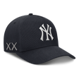 Structured navy New York Yankees snapback hat featuring KAWS x Nike branding and human-made design details.