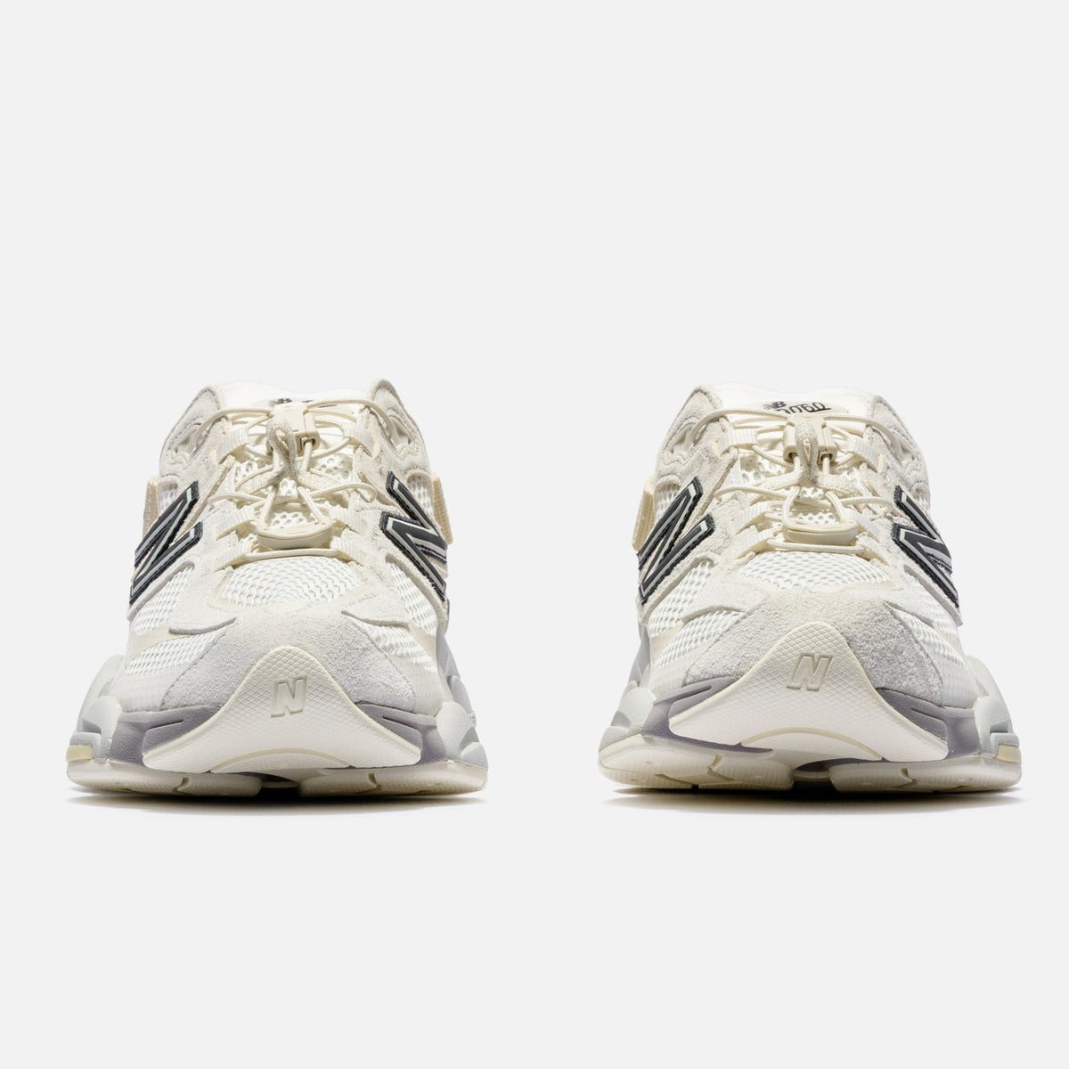 New Balance 9060 Mule sneakers in off-white and mauve with a sleek, modern design and comfortable fit.