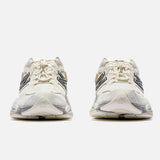 New Balance 9060 Mule sneakers in off-white and mauve with a sleek, modern design and comfortable fit.