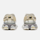 New Balance 9060 Mule sneakers in off-white and mauve with a sleek, modern design and comfortable fit.