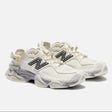 New Balance 9060 Mule sneakers in off-white and mauve with a sleek design and comfortable fit.