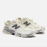 New Balance 9060 Mule sneakers in off-white and mauve with a sleek design and comfortable fit.