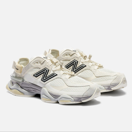 New Balance 9060 Mule sneakers in off-white and mauve with a sleek design and comfortable fit.