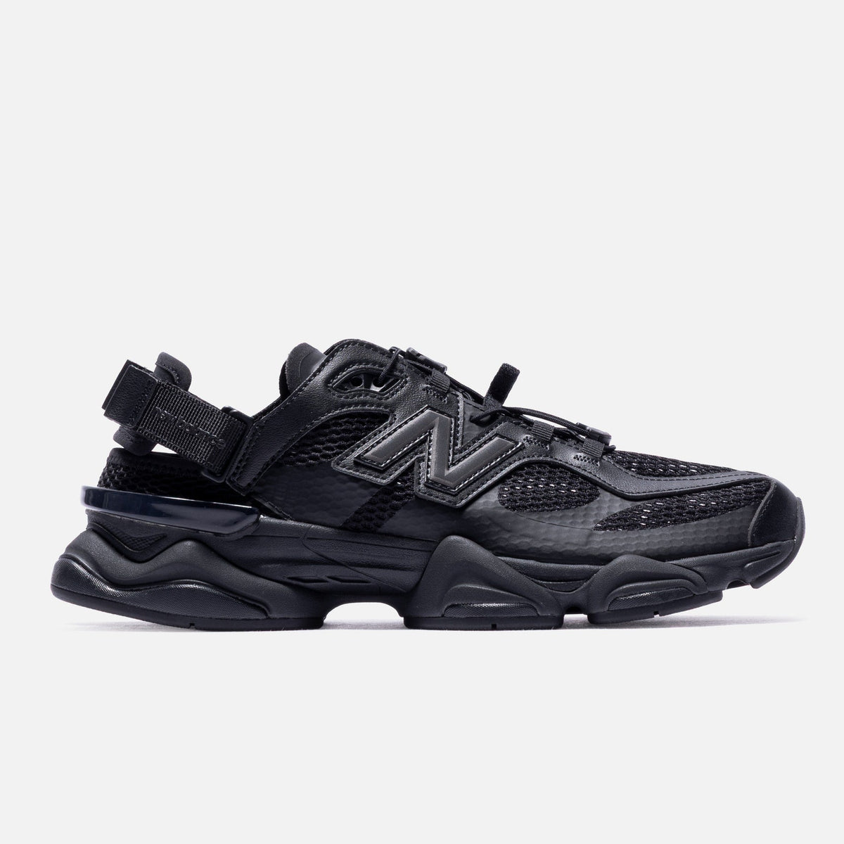 Black New Balance 9060 Mule sneakers, featuring a sleek, minimalist design with a comfortable fit and modern style.
