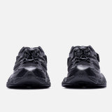 Black New Balance 9060 Mule sneakers featuring sleek design and cushioned soles, showcasing the stylish triple black colorway.