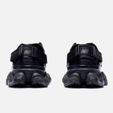 Black New Balance 9060 Mule sneakers with sleek design and padded sole, showcasing their comfortable, modern style.