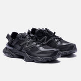Black New Balance 9060 Mule sneakers with sleek design and comfortable fit, showcased from a side angle.