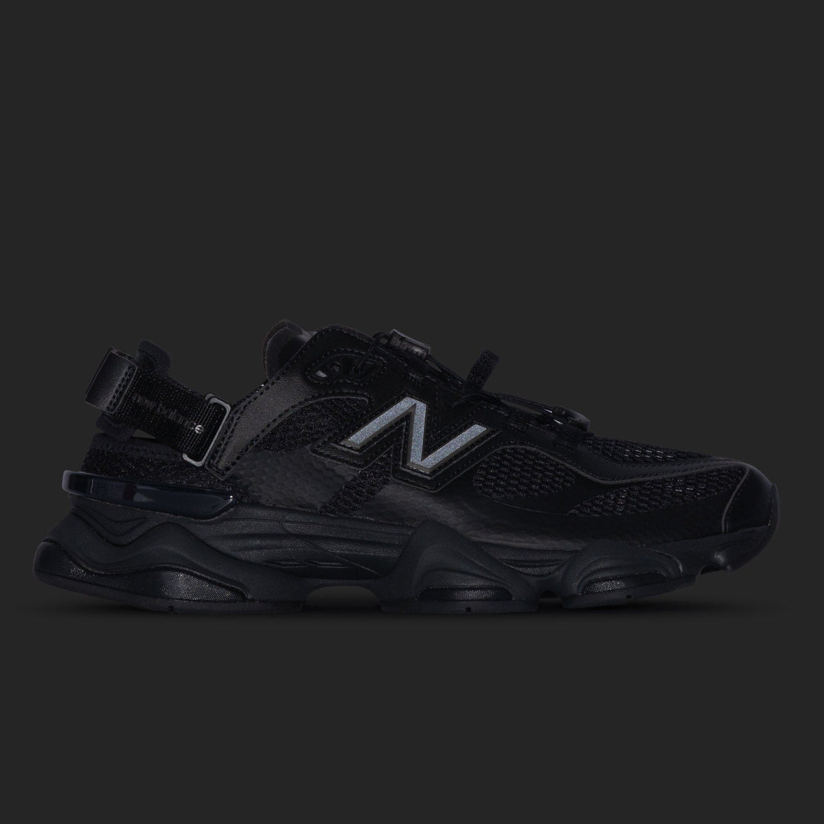 Black New Balance 9060 Mule sneakers featuring a sleek, minimalist design and comfortable fit.