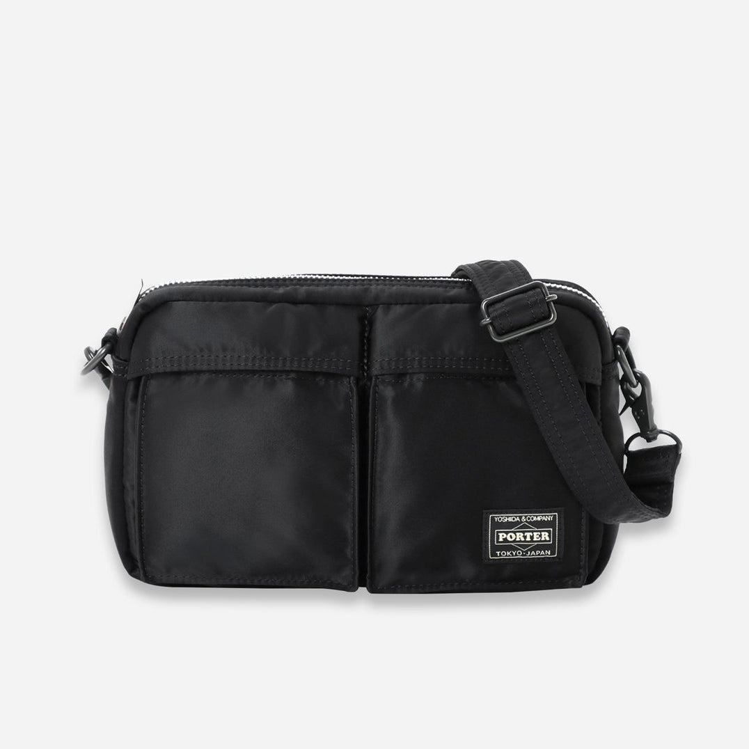 Black Porter Yoshida Japan Tanker Sling Bag with adjustable strap and sleek design, made from durable materials.