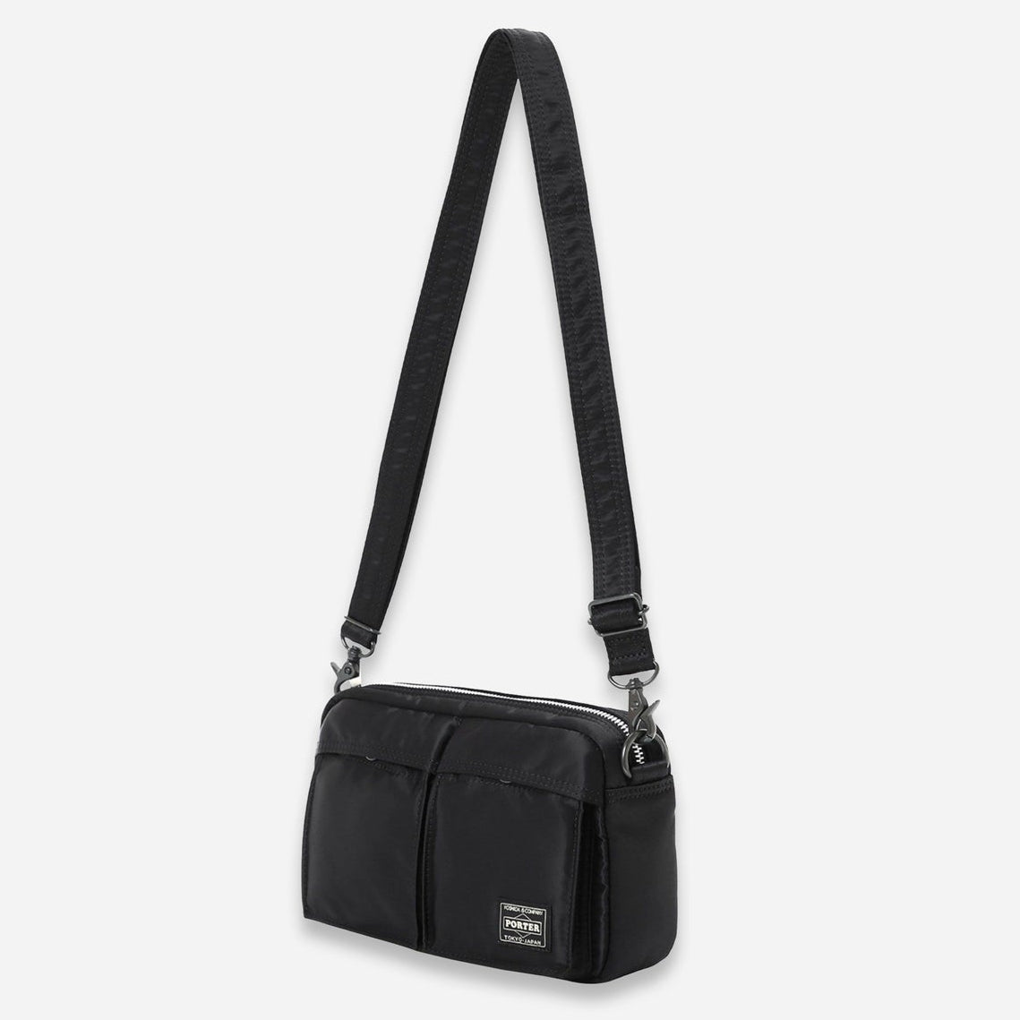 Black Porter Yoshida Japan Tanker Sling Bag showing its sleek design and adjustable strap made of durable material.