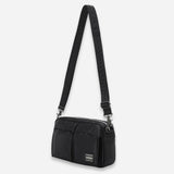 Black Porter Yoshida Japan Tanker Sling Bag showing its sleek design and adjustable strap made of durable material.