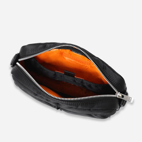 Black Porter Yoshida Japan Tanker Sling Bag with adjustable strap and multiple compartments, stylish and functional for everyday use.