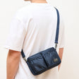 Porter Yoshida Japan Tanker Shoulder Bag in navy with adjustable strap, durable canvas material, and classic design.