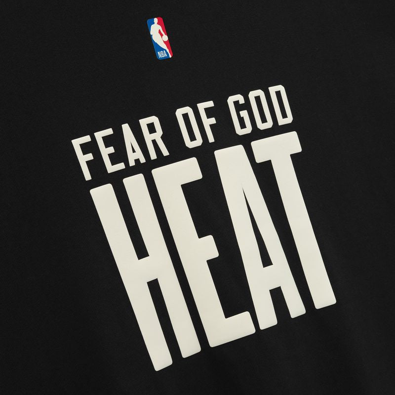 Fear of God Essentials NBA 90s Heavyweight Tee in black, featuring bold graphic design on a comfortable black cotton T-shirt.