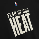 Fear of God Essentials NBA 90s Heavyweight Tee in black, featuring bold graphic design on a comfortable black cotton T-shirt.