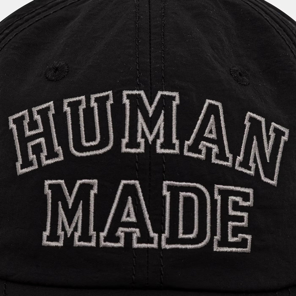 Black Human Made embroidered logo 6-panel cap, stylish headwear with detailed stitching and classic dad hat design.