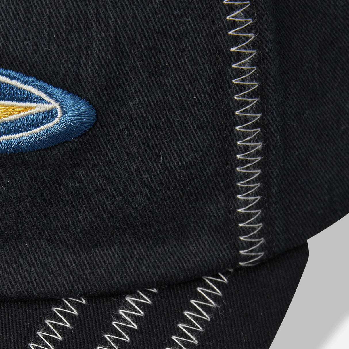 Black Stussy Oval Star Cap, stylish headwear with embroidered star logo, featuring a curved brim and adjustable strap.