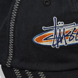 Black Stussy oval star cap, stylish headwear featuring the iconic star logo, shown from the front view.