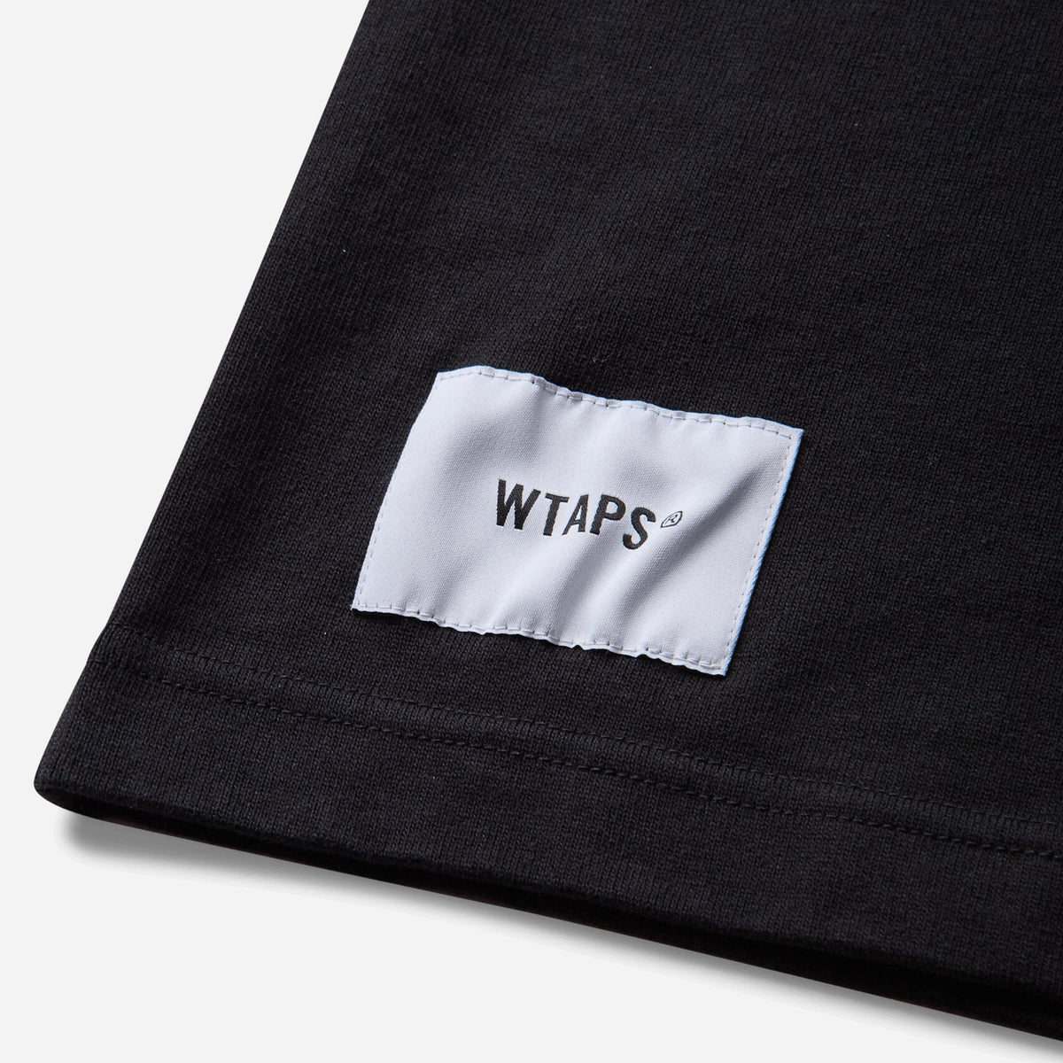 Black WTAPS pocket T-shirt made of cotton, featuring short sleeves and a classic crew neck design.