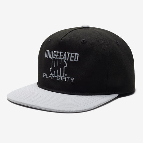 Black Undefeated Play Dirty snapback hat featuring bold branding and adjustable strap, styled as casual headwear.