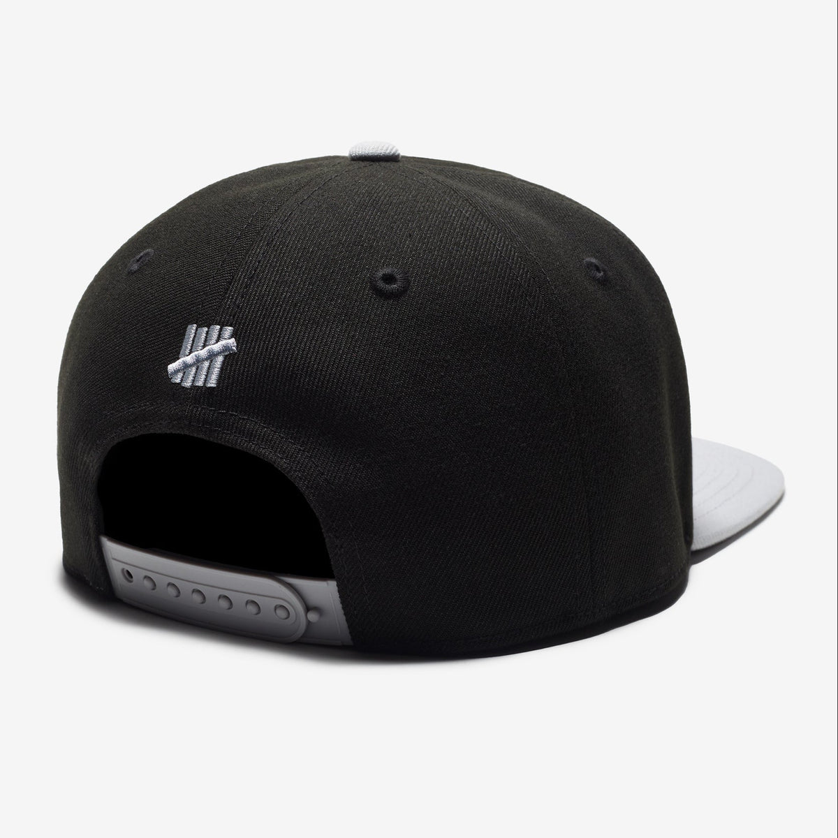 Black Undefeated Play Dirty snapback hat with adjustable strap and embroidered logo, stylish headwear for casual wear.