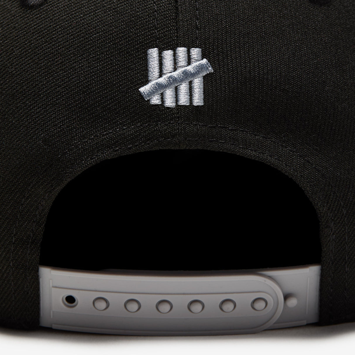 Black Undefeated Play Dirty Snapback hat, stylish headwear with embroidered branding, adjustable snapback closure, and flat brim.