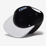 Black Undefeated Play Dirty Snapback hat featuring bold logo embroidery, casual headwear style with adjustable strap.