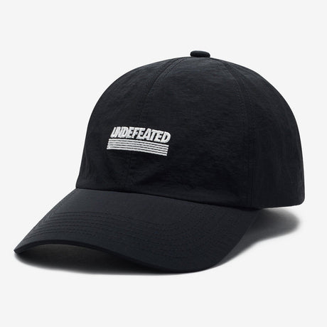 Black Undefeated logo strapback cap, stylish headwear with adjustable strap and bold branding, perfect for casual outfits.